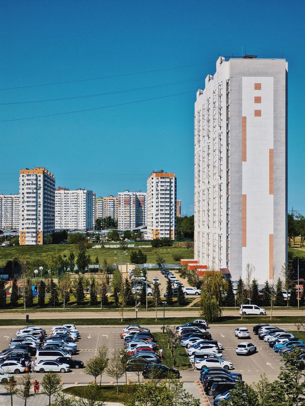 Residential towers overlooking a parking area.