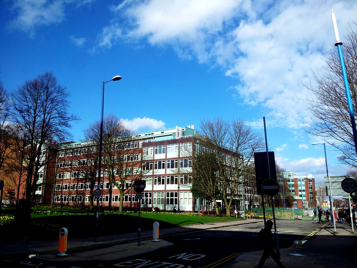 Campus building beside a street and pedestrian crossing.