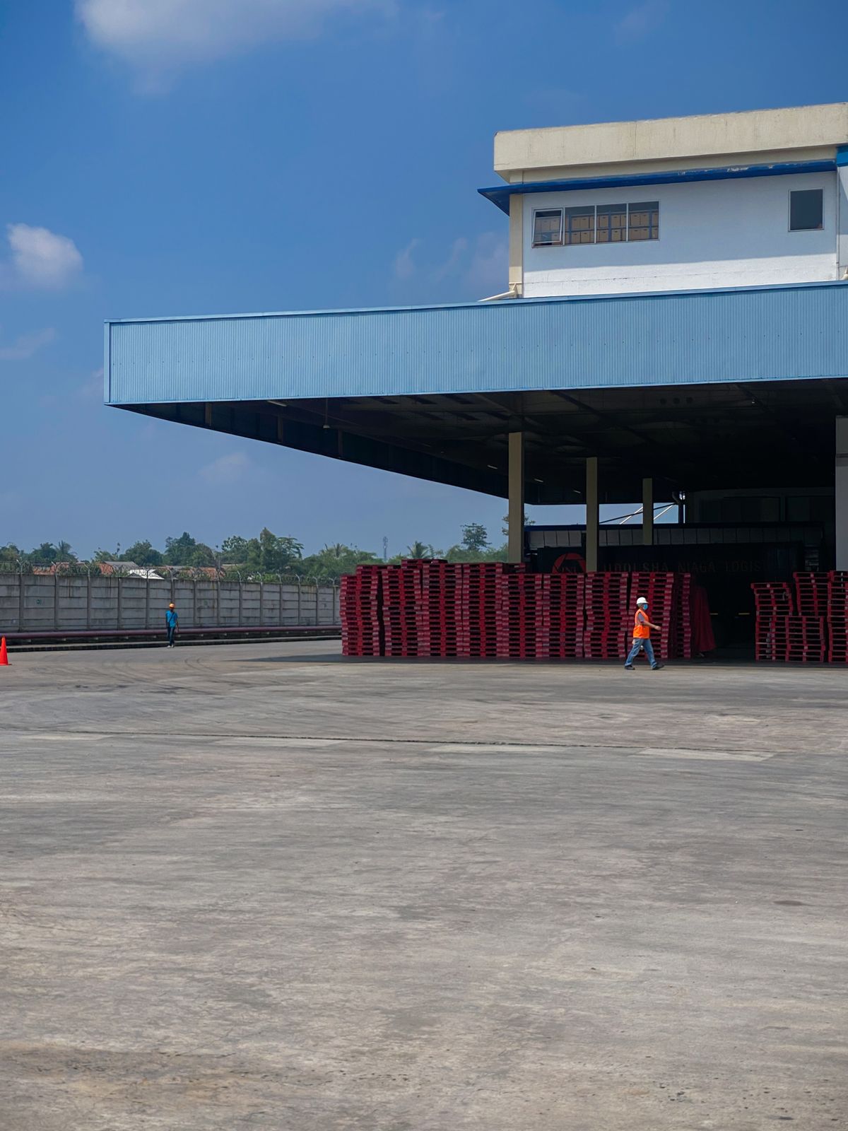 Warehouse loading canopy with an open paved yard.