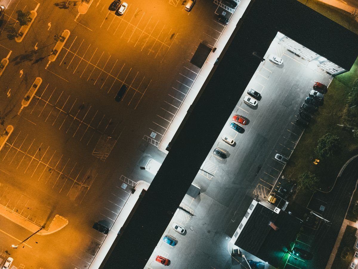 Aerial view of an illuminated parking lot at night.