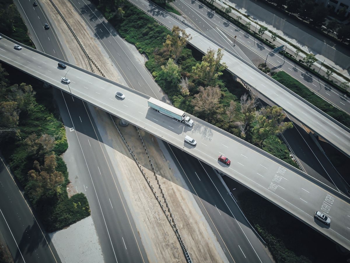 Aerial view of traffic lanes and a highway overpass.