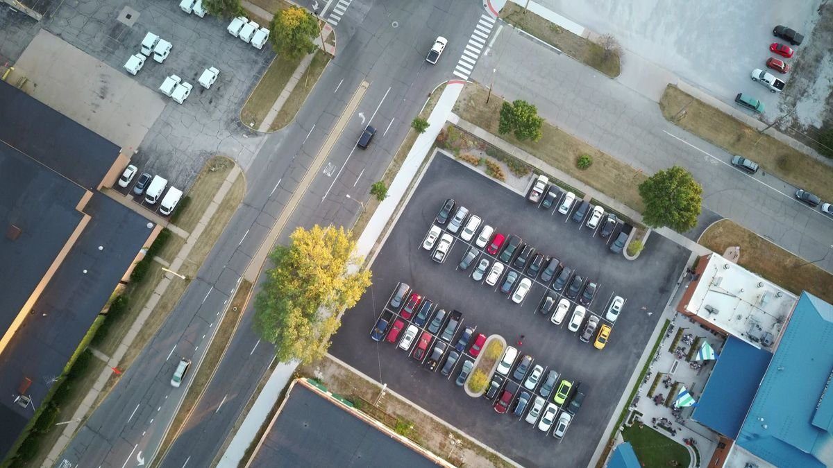 Aerial view of parking areas and surrounding paved streets.