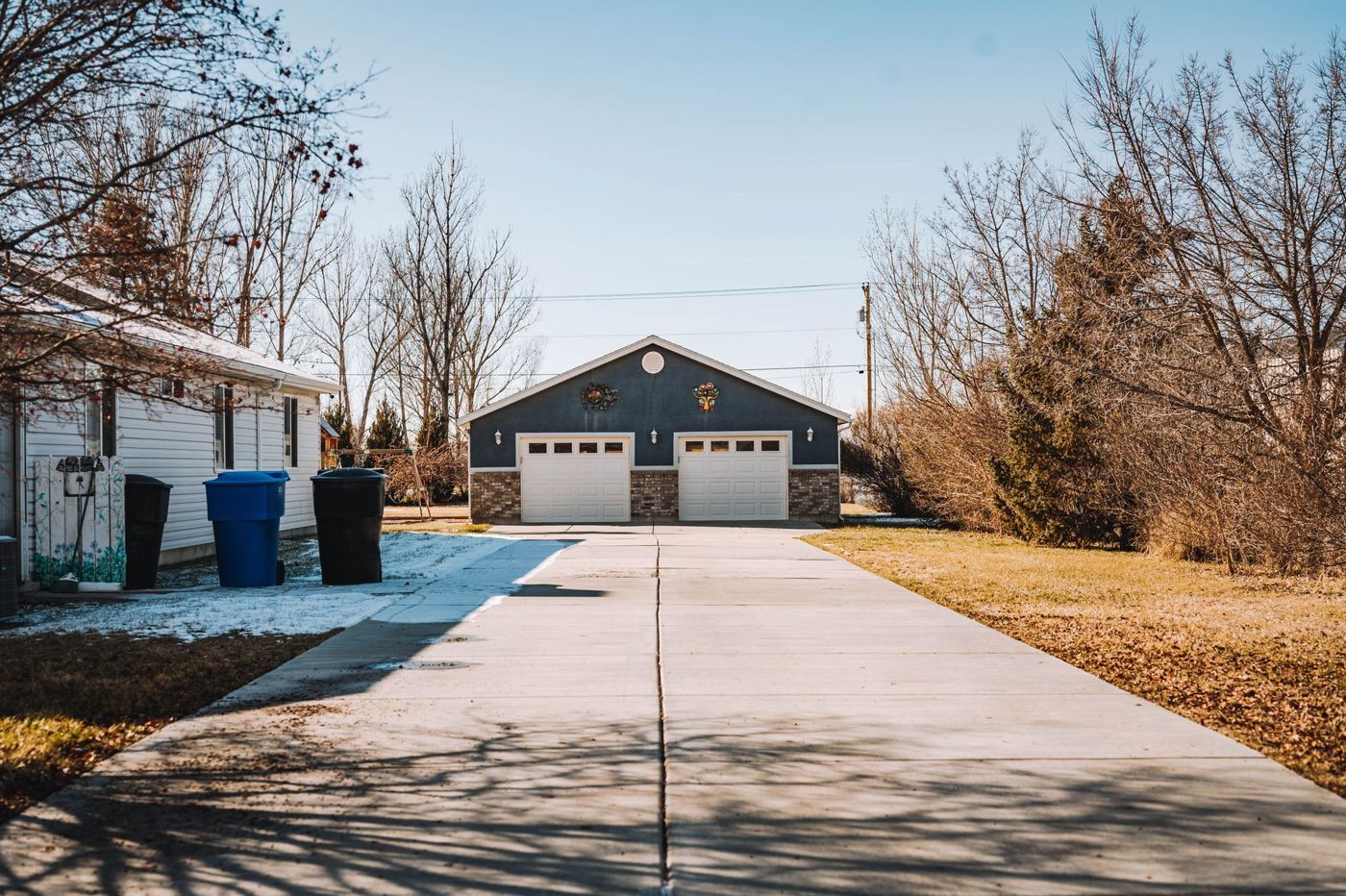 Residential driveway leading to a house and garage.