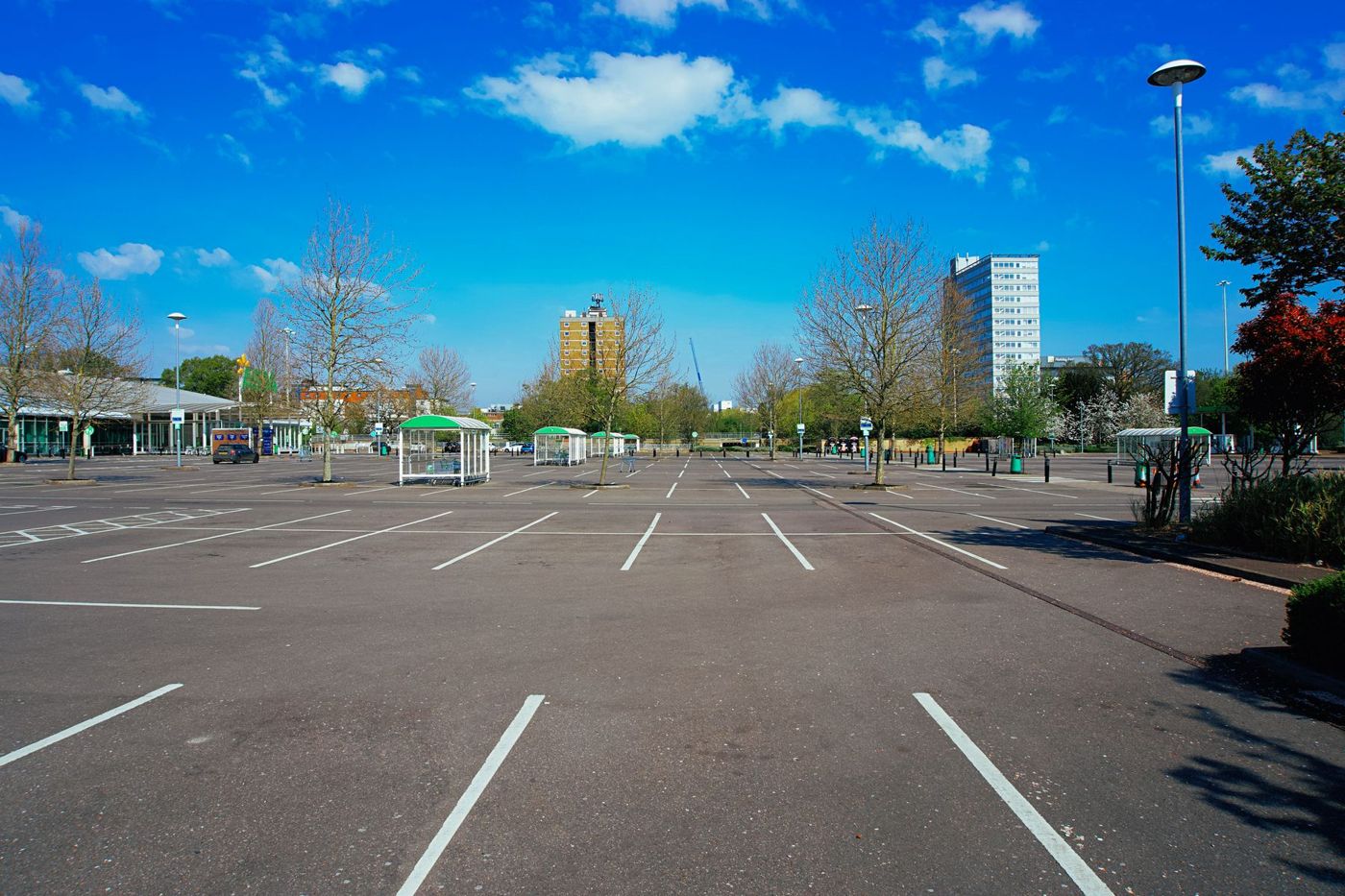 An open paved parking area with marked spaces.
