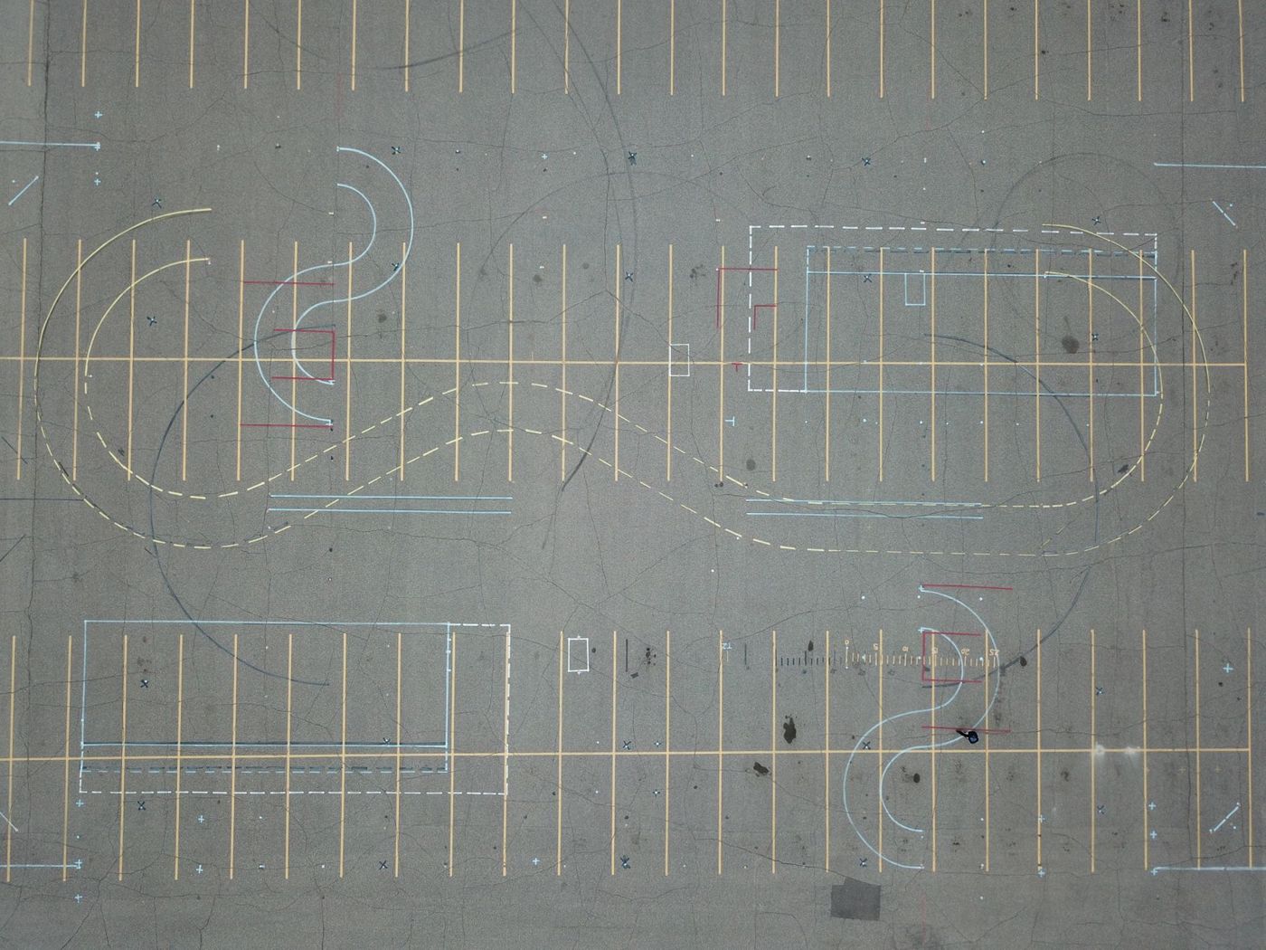 Aerial view of parking pavement and painted road markings.